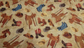 Mountain Pass Hats, Saddles and Boots Tan Background Quilt Fabric By Windham Fabrics
